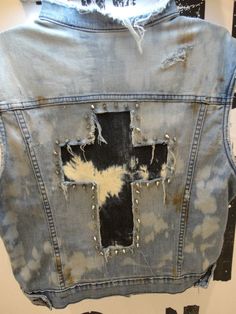 the back of a jean jacket with holes and rivets on it's sides