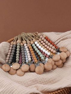 a basket filled with wooden beads on top of a blanket