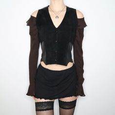 a mannequin wearing a black top and skirt