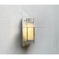 a white wall mounted light on the side of a building with no lighting in it