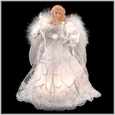 an angel figurine with white feathers and lights