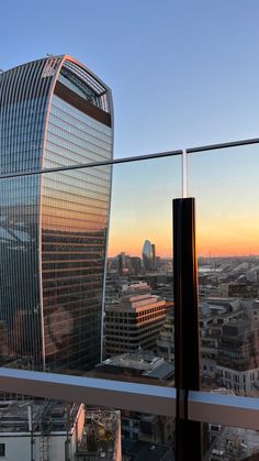 a view of the city from a high rise building in london, england at sunset