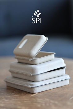 there is a stack of white plates on the table with spi logo above it