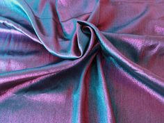 a purple and blue fabric is shown in close up view, it looks like the material has been dyed