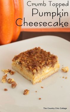 a piece of crumb topped pumpkin cheesecake on a white plate next to an orange pumpkin