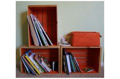 two bookshelves with magazines in them and a basket on the floor next to them