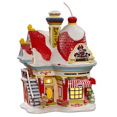 a christmas ornament with a house on the front and stairs leading up to it