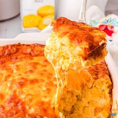 a casserole dish with cheese being lifted from it