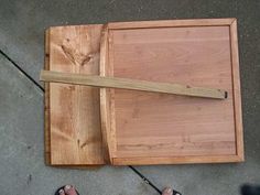 a person standing next to a wooden cutting board