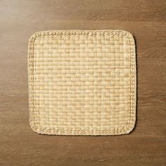 a square woven placemat on a wooden surface