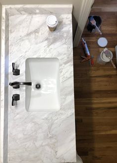 a white sink sitting on top of a marble counter