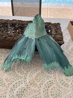 a piece of wood that has been painted green and is sitting on top of a table