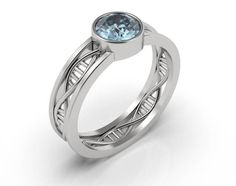 a white gold ring with a blue topazte stone in the center and diamond accents