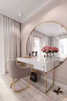 a dressing table with a mirror, chair and flowers on it