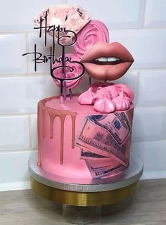 a pink birthday cake with money on top