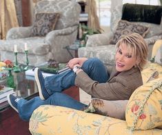 a woman sitting on top of a couch in a living room