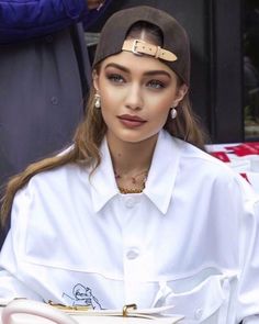 a woman in white shirt and brown hat