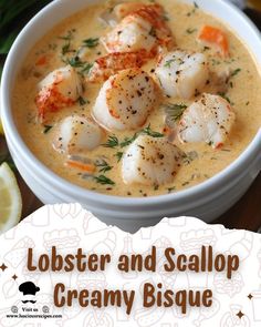 lobster and scallop creamy bisque in a white bowl with lemon wedges