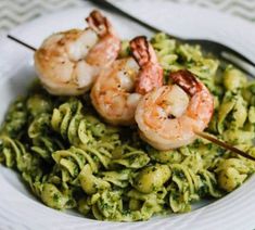 shrimp and pesto pasta on a white plate