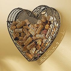 a heart shaped basket filled with cookies hanging on a wall