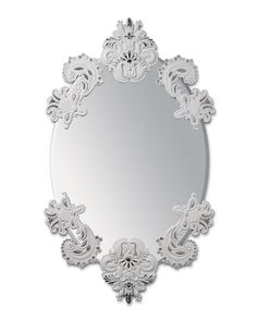 an ornately decorated mirror is shown on the white wall, and it looks like it has