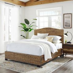 a bedroom with white walls and wood floors