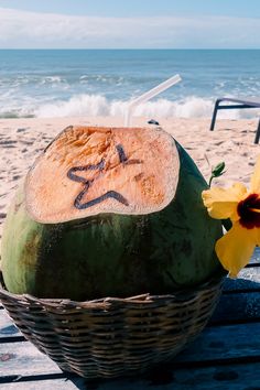 there is a coconut on the beach with a star drawn on it and a daffodil