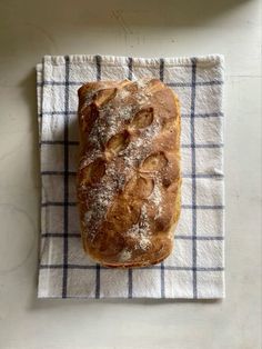 a loaf of bread sitting on top of a blue and white towel