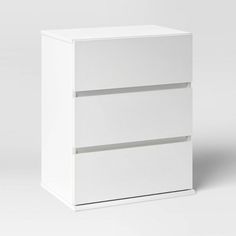 a white cabinet with two drawers sitting on top of it's sides, against a gray background