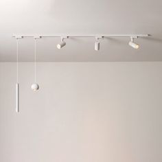 an empty room with several lights hanging from the ceiling