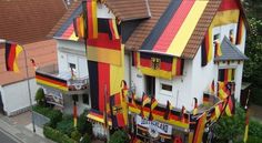 an aerial view of a multi - colored house with flags on the front and side