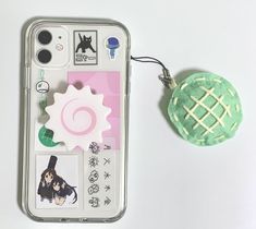 a cell phone case with some stickers on it and a keychain attached to it