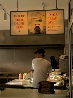 a man standing in front of a counter at a fast food restaurant with menus on the wall