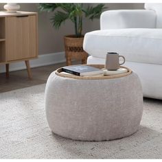 a coffee table sitting on top of a rug next to a white couch in a living room