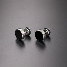 Unleash your inner style maverick with our Men's Stainless Steel Stud Earrings in sleek black. Crafted for the modern trendsetter, these earrings blend contemporary edge with timeless sophistication. Forged from high-quality stainless steel, these studs exude durability and resilience, ensuring they stand the test of time. The sleek black finish adds a touch of understated elegance, making them versatile enough to complement any ensemble, whether casual or formal. With a minimalist design, these earrings offer a subtle yet impactful accent to your look, effortlessly elevating your style game. Lightweight and comfortable to wear, they are perfect for everyday wear or special occasions, adding a dash of confidence and charisma to your persona      Earrings Height: 10mm Width: 10mm     Materi Modern Adjustable Black Jewelry, Minimalist Black Stainless Steel Earrings, Adjustable Matte Black Modern Jewelry, Modern Matte Black Adjustable Jewelry, Nickel-free Black Metal Plug Earrings, Modern Stainless Steel Earrings, Modern Adjustable Nickel-free Plug Earrings, Modern Black Hypoallergenic Jewelry, Modern Silver Earrings With Black Enamel