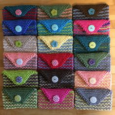 many different colored knitted items are arranged in rows with buttons on the top and bottom