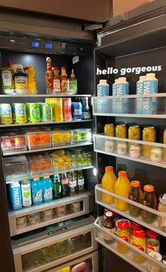 an open refrigerator filled with lots of food and drinks in it's door shelves