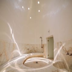 a circular bathroom with marble walls and floor