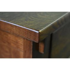 a close up view of the top of a wooden table with green paint on it