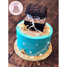 a birthday cake decorated with an image of a pirate's ship and pearls on top