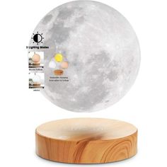 the moon lamp is sitting on top of a wooden stand with instructions to make it glow