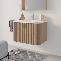 a bathroom vanity with a mirror above it and shoes on the floor next to it