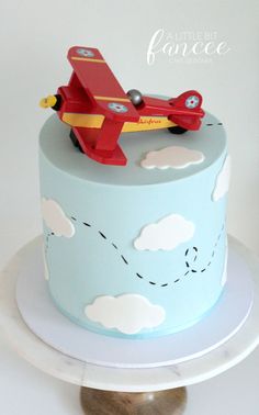 a blue cake with a red plane on top