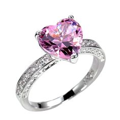 a pink heart shaped ring with diamonds on the sides and an accent band around it