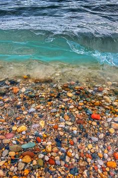 an ocean view with rocks and water in the foreground