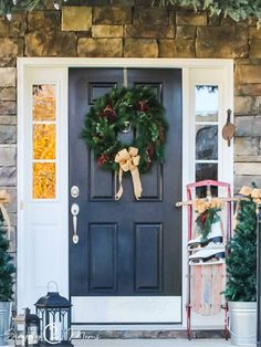 a front door decorated for christmas with wreaths and decorations