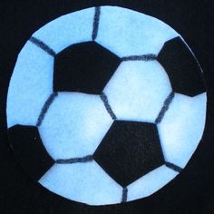 a black and white soccer ball painted on the surface of a round table top,