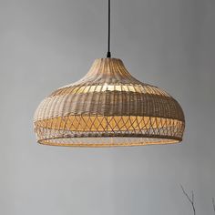 a light that is hanging from a ceiling in a room with gray walls and flooring