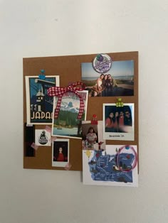 a bulletin board with pictures and magnets on it's side, attached to the wall