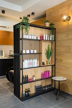 a shelf filled with lots of different types of hair care products next to a table